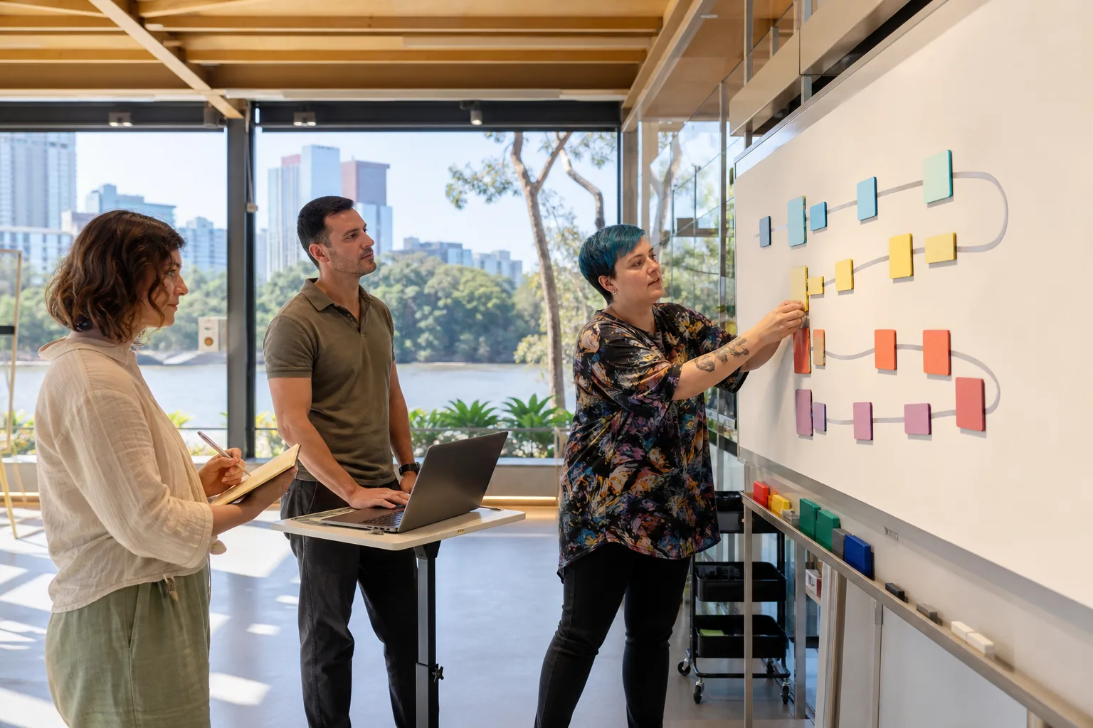 Participant arranging goal pathways on an accessible wall board during a first support coordination meeting in Brisbane.